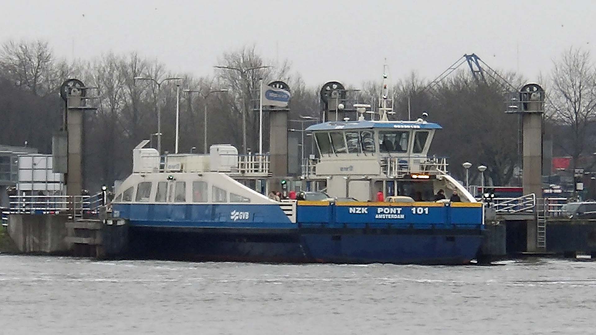 Electric GVB ferry NZK 101 crossing the North Sea Canal at Hempont, viewed broadside on the water.